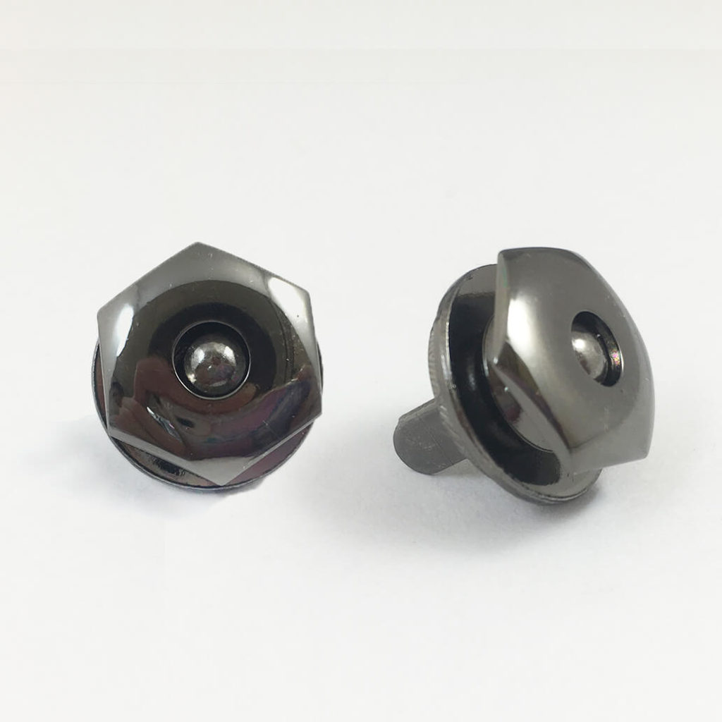 Hexagonal magnetic snap button in polished gunmetal finish.