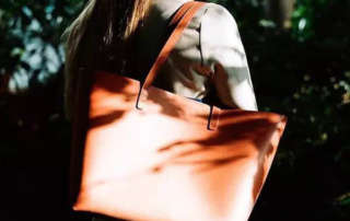 Large tote bag with a magnetic snap closure, designed for style and functionality, ideal for everyday use and customizable for bulk orders.