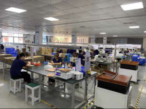 Skilled workers assembling magnets by hand in a workshop, ensuring precision and quality in the magnet production process.