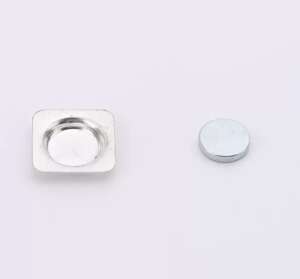 Disassembled square magnetic badge components showing back plate and magnet