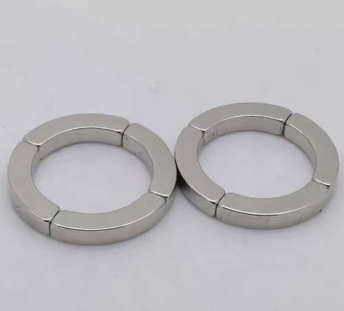 Curved arc segment magnets fitted together into two complete rings