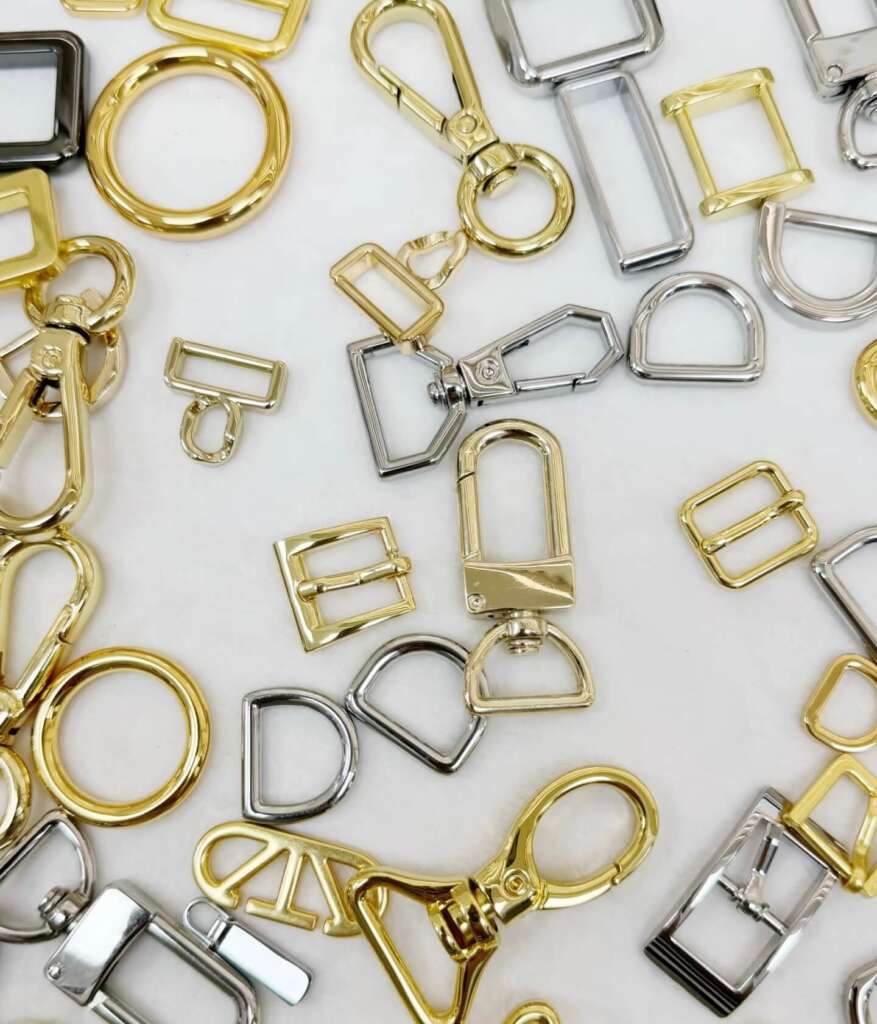 Various types of purse clasps including D-rings, buckles, and snap hooks in gold and silver finishes.