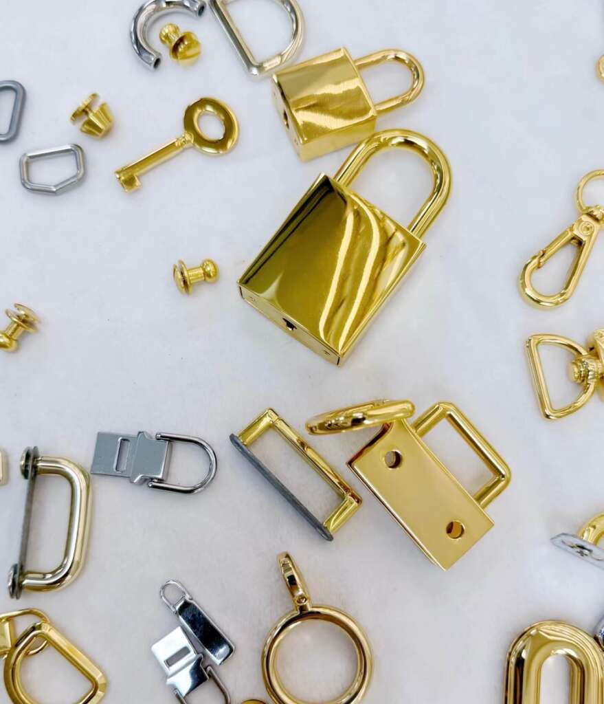 Padlocks, buckles, and ring fasteners laid out as examples of purse clasp options.