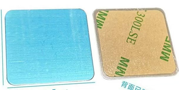 Close-up of square silver adhesive magnetic metal plates with blue protective film and 3M 300LSE backing, available in 25mm, 34mm, and 40mm sizes.