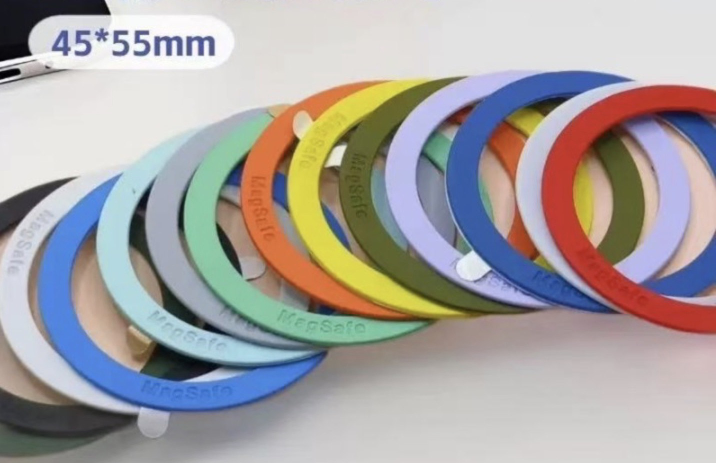 A row of colorful liquid silicone rubber (LSR) magnetic rings, each labeled “MagSafe,” arranged in a curve with 45×55mm size, showcasing IP68 waterproof silicone cladding.