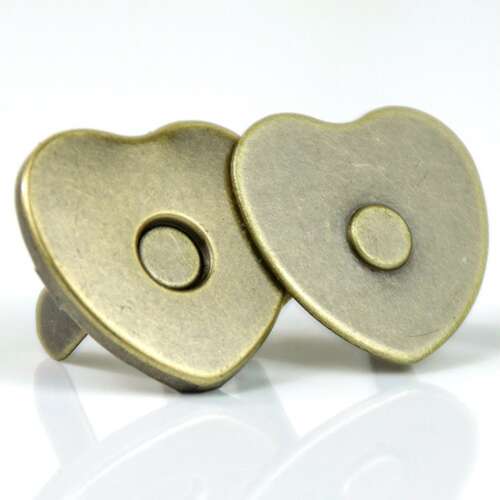 Two heart-shaped magnetic snap halves in an antique-tone finish